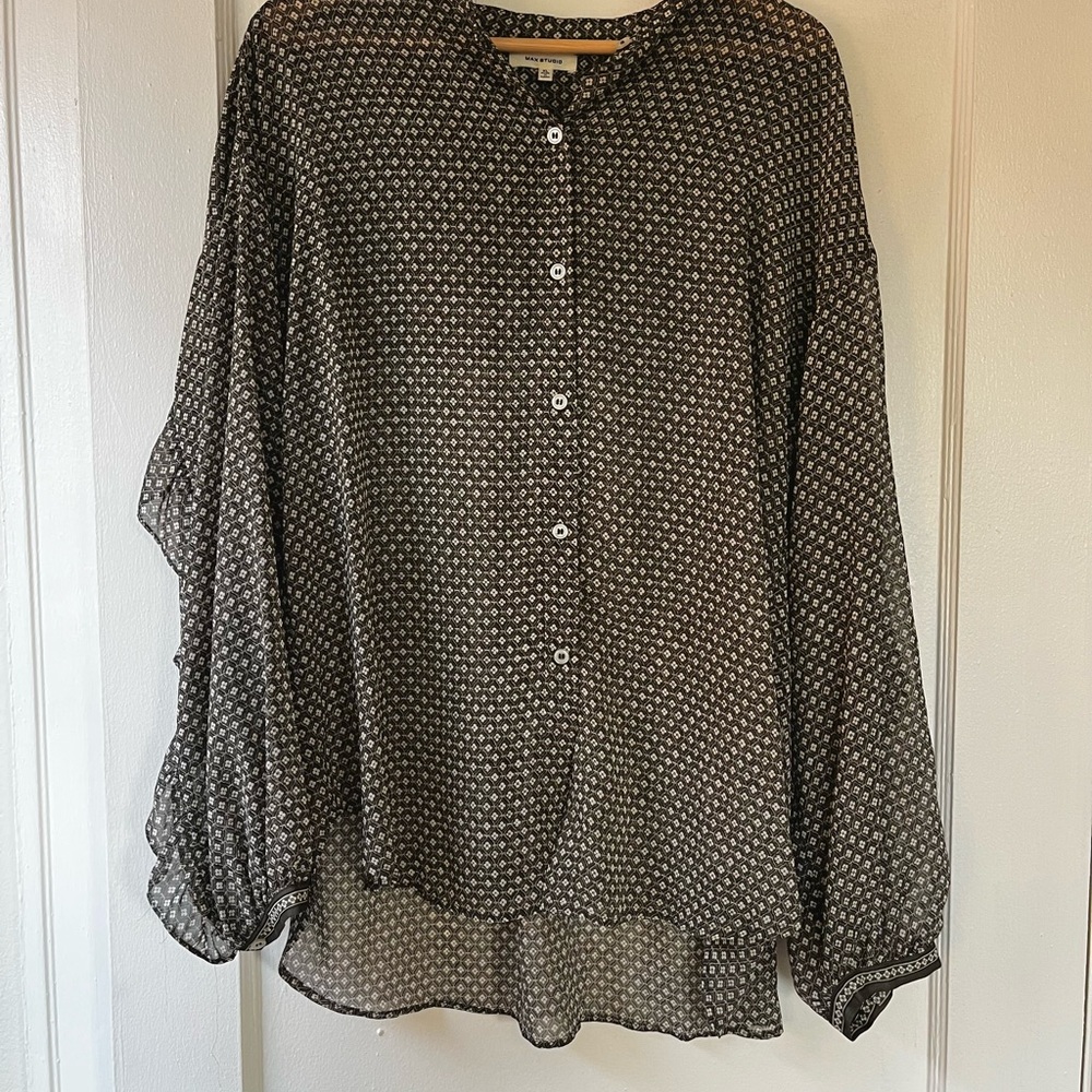Semi-sheer bohemian ruffle button-up blouse.